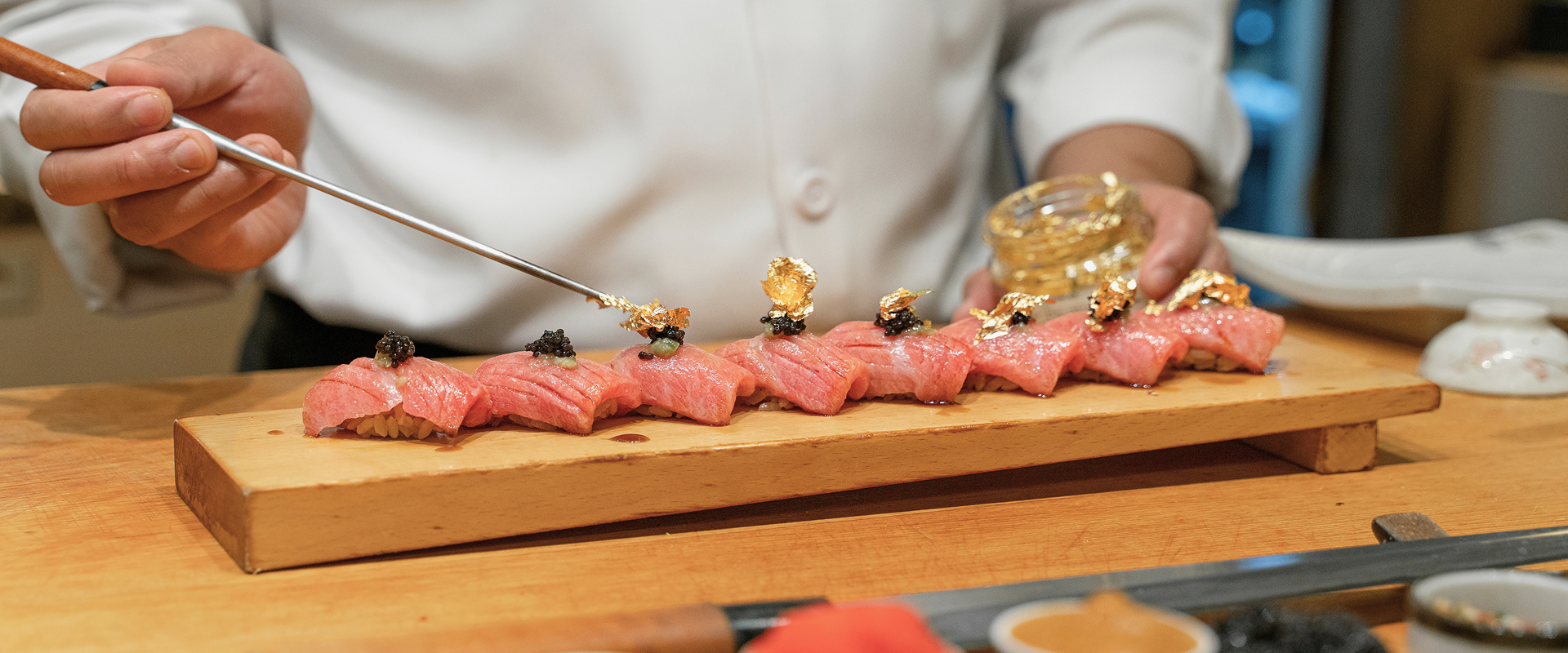 KT - Photo of a chef making sushi