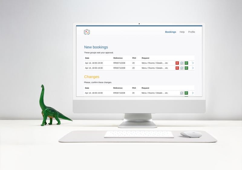 KT - Photo of a toy dinosaur and a computer