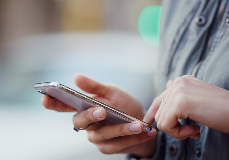 KT - Person scrolling on phone