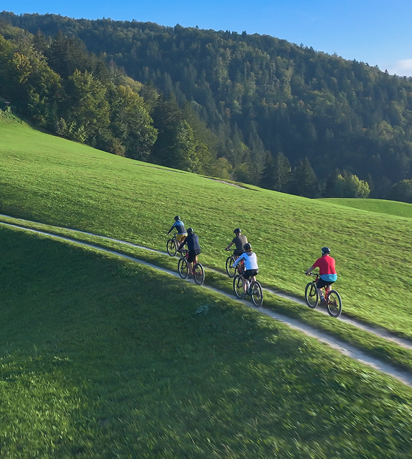 KT - People riding bike on a hill