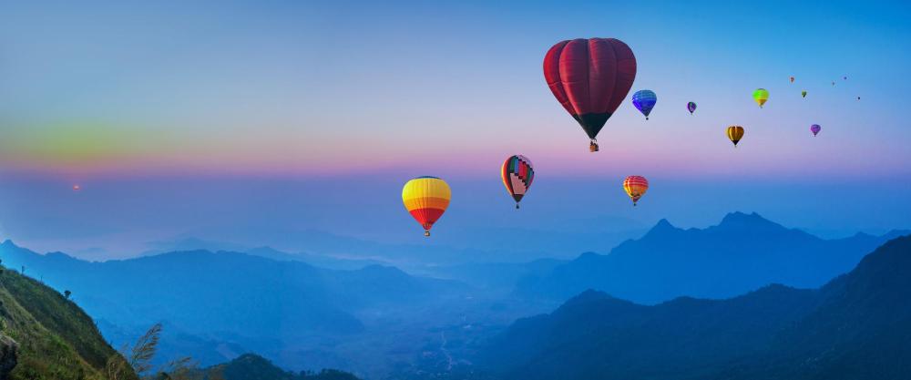 KT -  Many hot air balloon above mountain