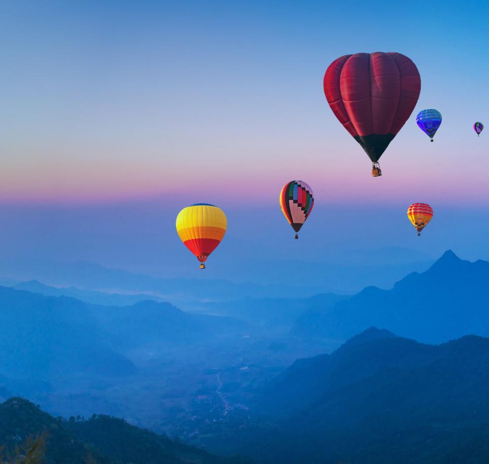 KT -  Many hot air balloon above mountain