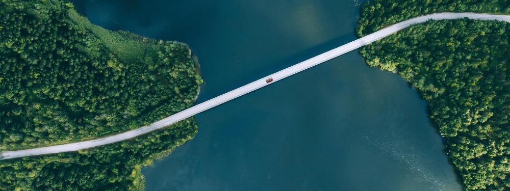 KT - Aerial View of Car driving on a bridge to another island